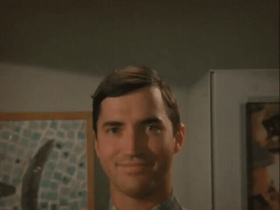 Man Smiling At Camera In Front Of Painting GIF