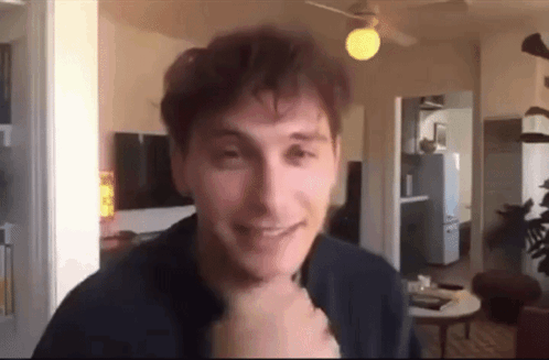 Man Smiling At Camera In Living Room GIF