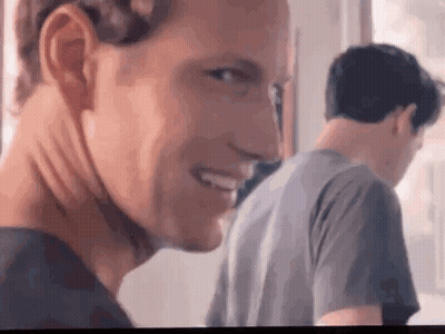 Man Smiling At Camera With Man Behind GIF
