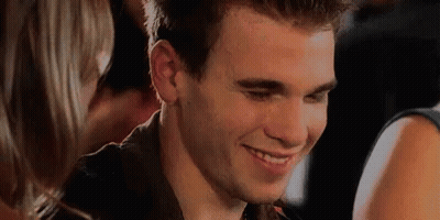 Man Smiling At Woman In Crowd GIF