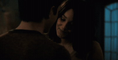 Man Smiling At Woman In Dark Room GIF