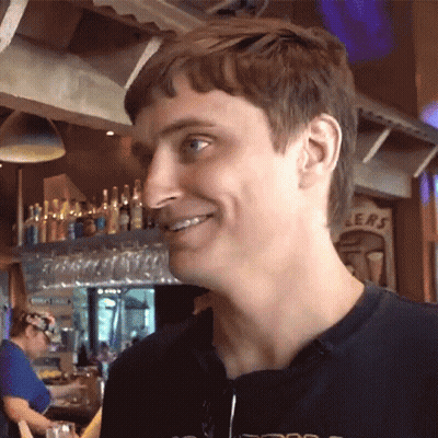 Man Smiling Beside Sign Saying Ers GIF