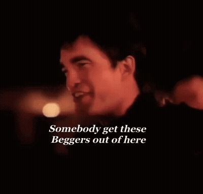 Man Smiling Dark Room Saying Somebody Get These Beggars Out Of Here GIF