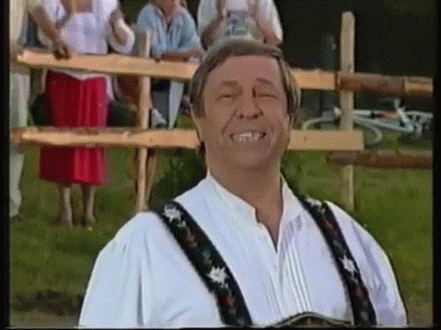 Man Smiling Eyes Closed By Wooden Fence GIF