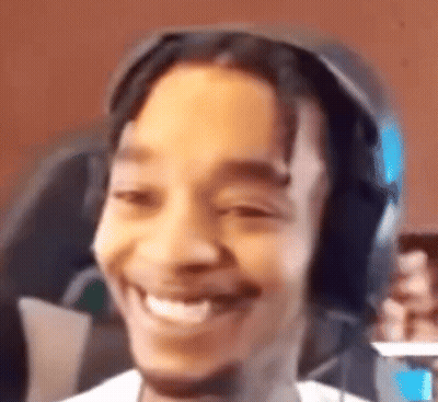 Man Smiling Holding Cell Phone With Headphones GIF