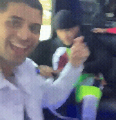 Man Smiling Holding Neon Green Item GIF