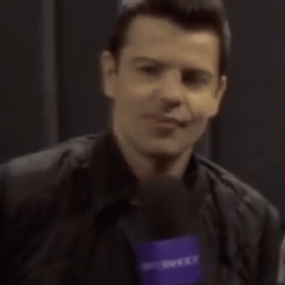Man Smiling Holding Yahoo Microphone GIF
