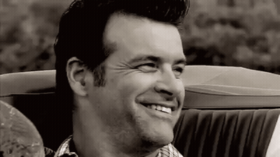 Man Smiling In Black And White Convertible Car GIF