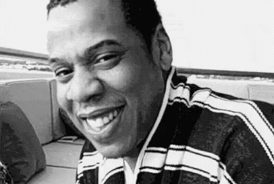 Man Smiling In Black And White On Couch GIF