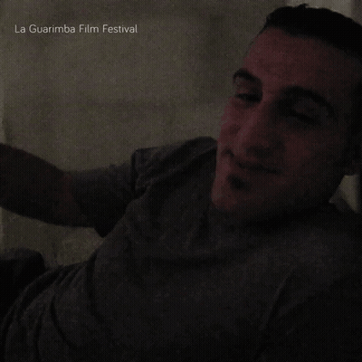 Man Smiling In Dark Room La Guarimba Film Festival GIF