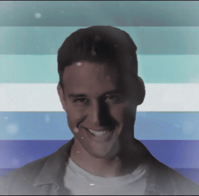 Man Smiling in Front of Blue White and Green Striped Background
