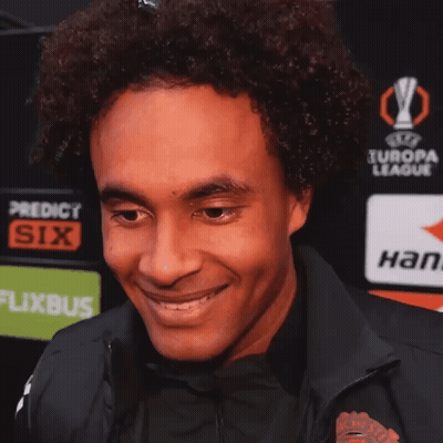 Man Smiling In Front Of Europa League Advertisement GIF