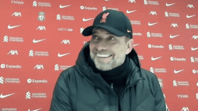 Man Smiling In Front Of Expedia Wall GIF