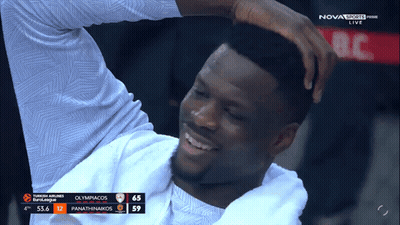Man Smiling In Front Of Nova Sports Prime Live Scoreboard GIF