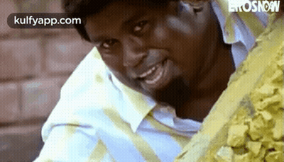 Man Smiling In Front Of Rocks GIF