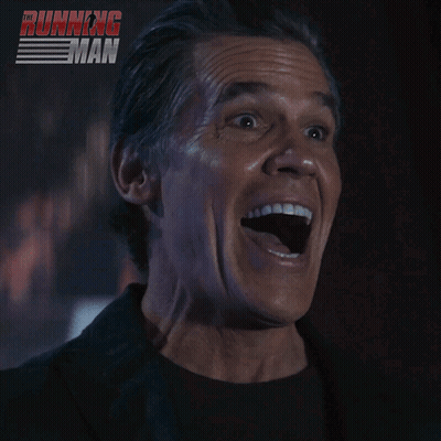 Man Smiling In Front Of Running Poster GIF