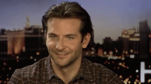 Man Smiling In Plaid Shirt At Night City GIF