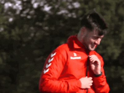 Man Smiling In Red Jacket With Arrows GIF