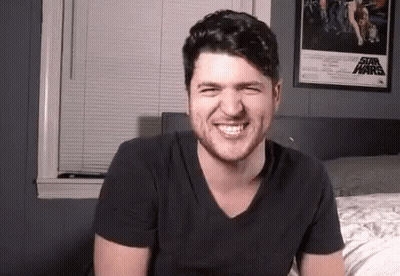 Man Smiling On Bed With Star Wars Poster GIF