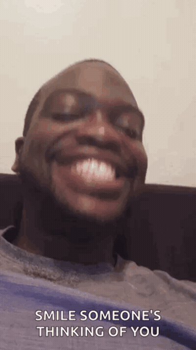 Man Smiling On Couch Saying Smile Someone's Thinking Of You GIF