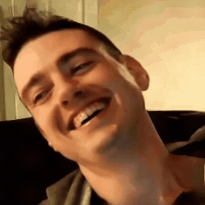 Man Smiling On Couch GIF