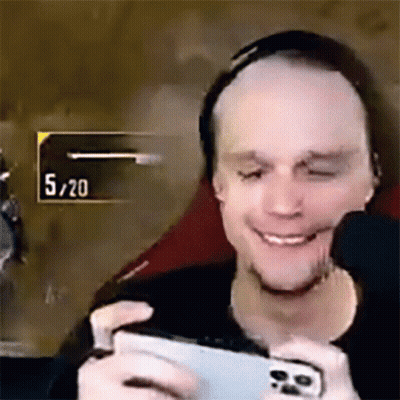 Man Smiling Playing Video Game On Cell Phone GIF