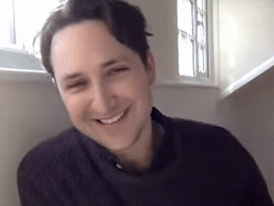 Man Smiling Sitting In Front Of Window GIF