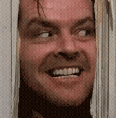Man Smiling Through Hole In Wall GIF