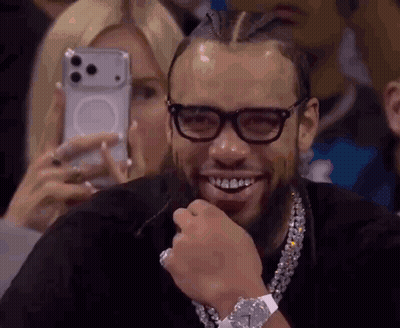 Man Smiling While Woman Takes Photo GIF