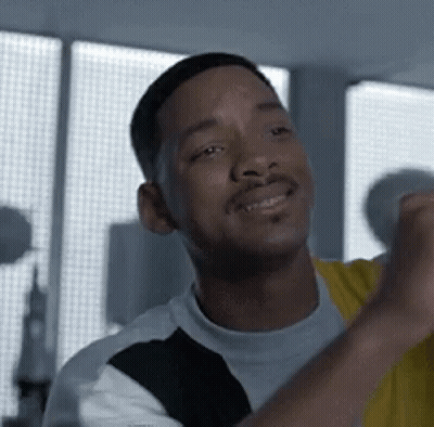 Man Smiling With Fist Up At Window GIF