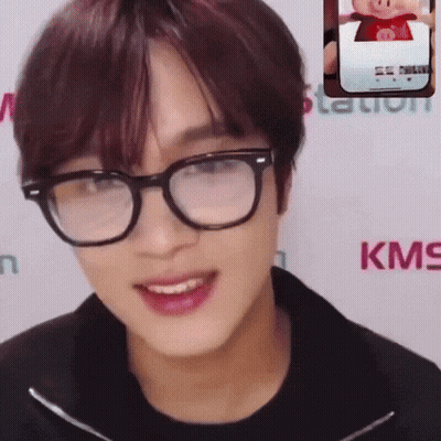 Man Smiling With Glasses Next To KMS Logo GIF