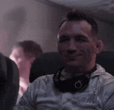 Man Smiling With Headphones On Airplane GIF