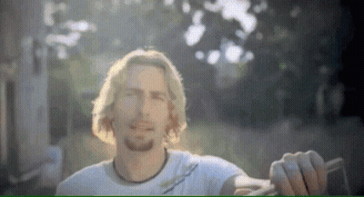 Man Smiling With I'm a Traitor Behind Him