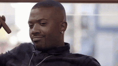 Man Smoking Cigar And Smiling With Necklace GIF