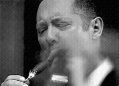 Man Smoking Cigar Holding Fork In Mouth GIF