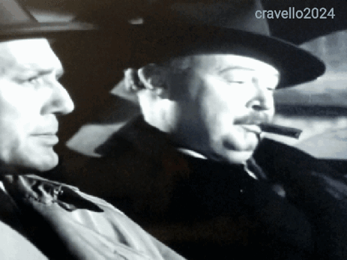 Man Smoking Cigar Next To Cravello 2024 GIF