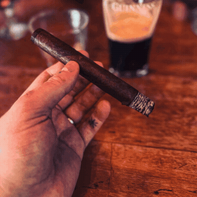 Man Smoking Cigar With Arm Tattoo GIF