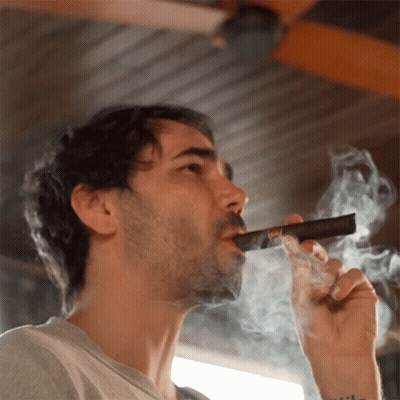 Man Smoking Cigar With Tattoo Saying I'll GIF