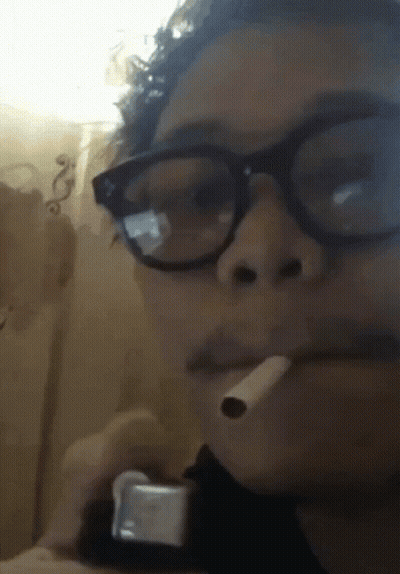 Man Smoking Cigarette Eyes Closed In Dark Room GIF