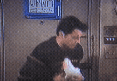 Man Smoking Cigarette Holding Duck In Front Of Welcome Sign GIF