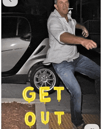 Man Smoking Cigarette in Front of Car Saying Get Out