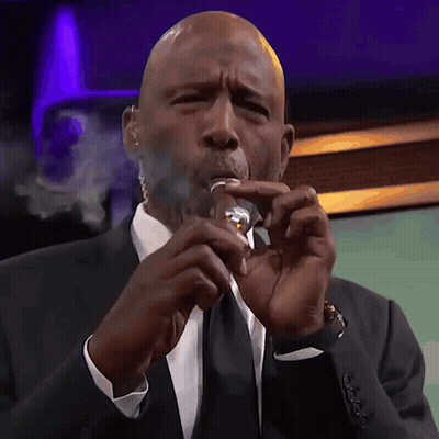 Man Smoking Cigarette In Front Of Cravello20202 Sign GIF