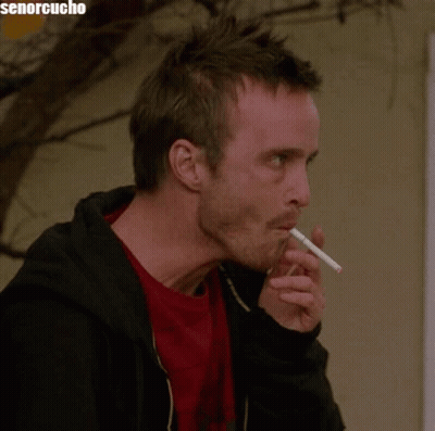 Man Smoking Cigarette In Front Of Senorcucho Sign GIF