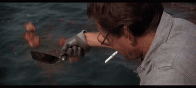 Man Smoking Cigarette In Front Of Shark In Ocean GIF