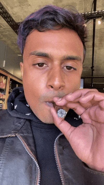 Man Smoking Cigarette In Parking Lot At Night GIF