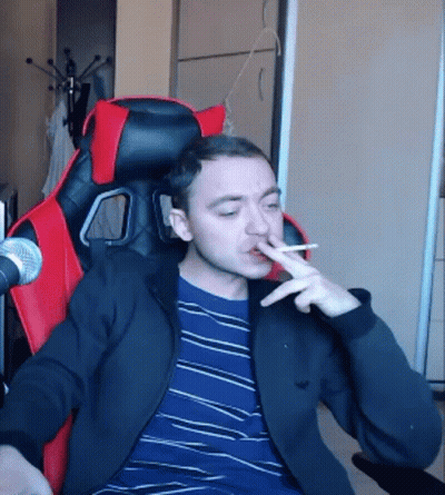 Man Smoking Cigarette In Red And Black Chair GIF