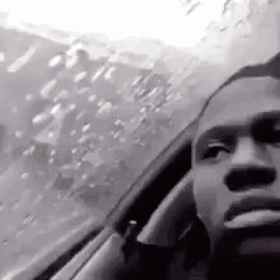 Man Smoking Cigarette Looking Out Car Window GIF