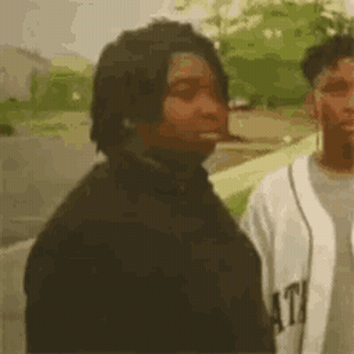 Man Smoking Cigarette Next To Baseball Player GIF