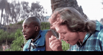 Man Smoking Cigarette While Another Man Looks On GIF