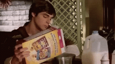 Man Smoking Cigarette While Eating Cereal GIF
